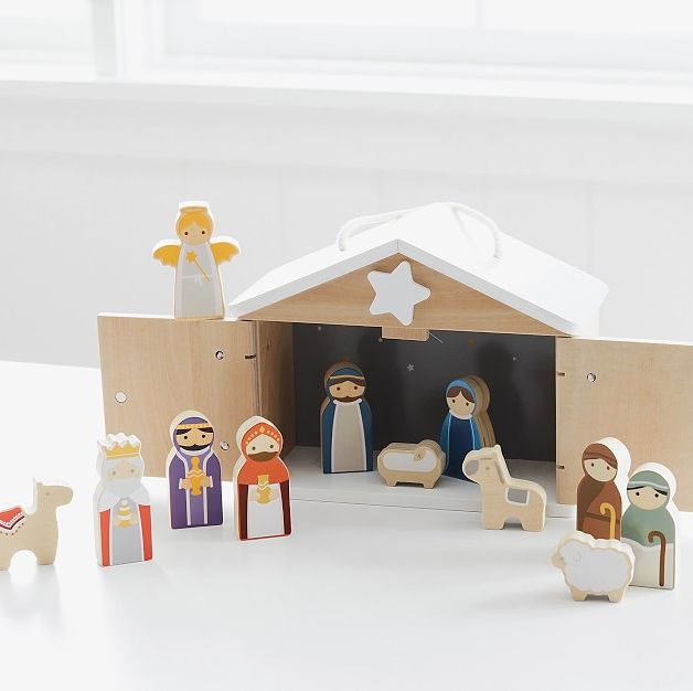 A cute Nativity set made out of wood, for children, with a stable, three magi, two shepherds, an angel, Mary, Joseph and Jesus in a manger, a camel, a sheep, and a donkey, all looking suitable for toddlers to play with.