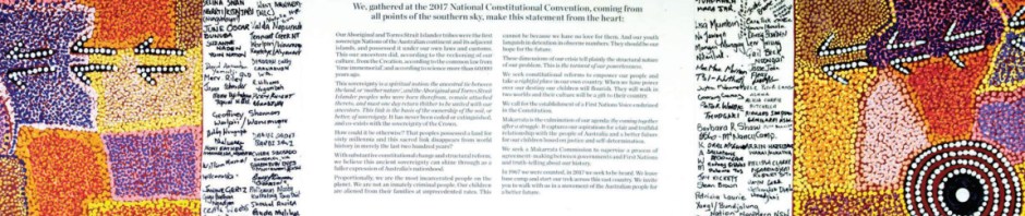 The Uluru Statement from the Heart, written on canvas, surrounded by the signatures of everyone who attended the Mutitjula dialogue, and bordered by a painting of the Tjukurrp (law/lore) of Uluru.