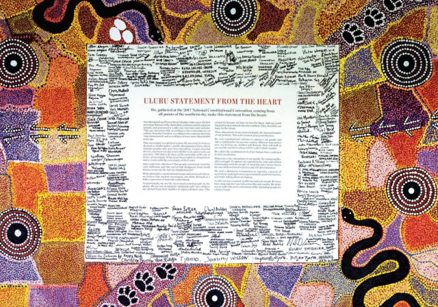 The Uluru Statement from the Heart, written on canvas, surrounded by the signatures of everyone who attended the Mutitjula dialogue, and bordered by a painting of the Tjukurrp (law/lore) of Uluru.
